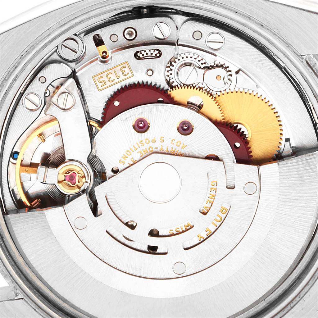 This image shows the intricate internal machinery of a Rolex Date 115234 Men's Stainless Steel Silver Dial 115234 Men's Stainless Steel Silver Dial model watch, viewed from the back.