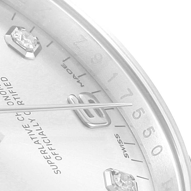 The image shows a close-up of the dial of a Rolex Date 115234 Men's Stainless Steel Silver Dial 115234 Men's Stainless Steel Silver Dial watch, highlighting the hour markers and part of the second hand.
