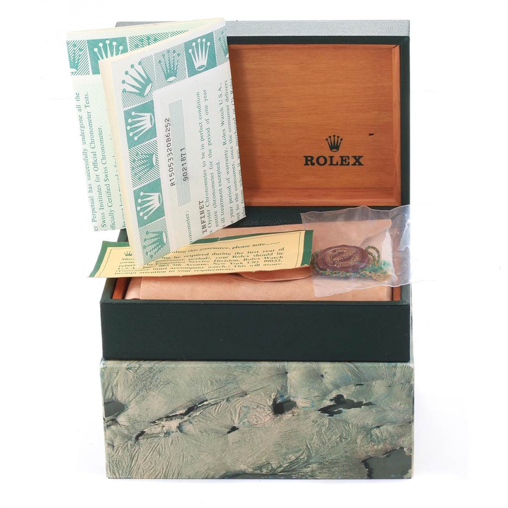 This image shows an open Rolex Date 15053 Men's Steel and Gold (two tone) Champagne Dial 15053 Men's Steel and Gold (two tone) Champagne Dial watch box with manuals, a tag, and documents.