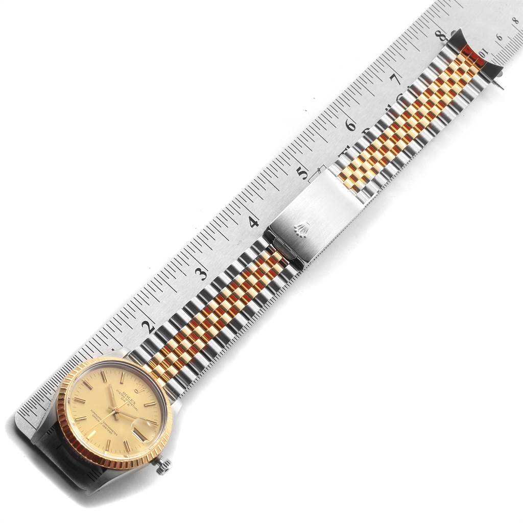 The image shows a Rolex Date 15053 Men's Steel and Gold (two tone) Champagne Dial 15053 Men's Steel and Gold (two tone) Champagne Dial model watch with a two-tone Jubilee bracelet and a ruler indicating measurements.