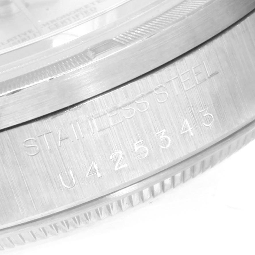 This close-up angle shows the serial number and "STAINLESS STEEL" engraving on the case of a Rolex Date 15210 Men's Stainless Steel Silver Dial 15210 Men's Stainless Steel Silver Dial model watch.