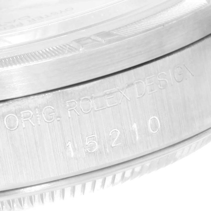 This image shows a close-up of the side view of a Rolex Date 15210 Men's Stainless Steel Silver Dial 15210 Men's Stainless Steel Silver Dial model watch casing, highlighting the engraved text and part of the bezel.