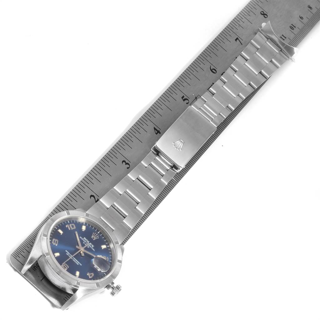 The image shows a top-down view of a Rolex Date 15210 Men's Stainless Steel Blue Dial 15210 Men's Stainless Steel Blue Dial model watch, showcasing the face, bracelet, and clasp along a ruler for scale.