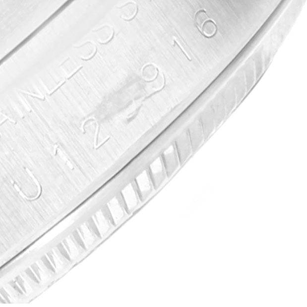 The image shows a close-up of the case back and edge, including engravings, of a Rolex Date 15210 Men's Stainless Steel Blue Dial 15210 Men's Stainless Steel Blue Dial model watch.