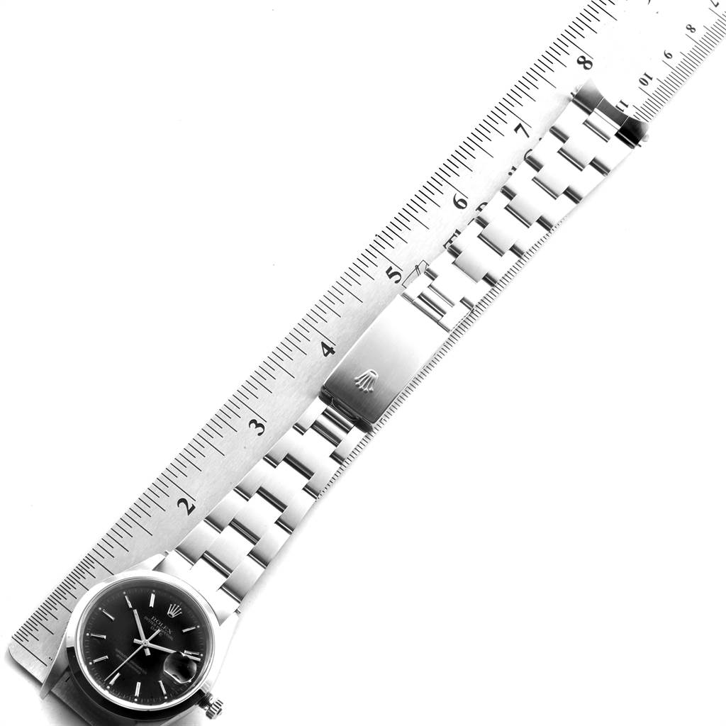 The image shows a Rolex Date 15200 Men's Stainless Steel Black Dial 15200 Men's Stainless Steel Black Dial watch with a metal bracelet and clasp, measured against a ruler at an angle.