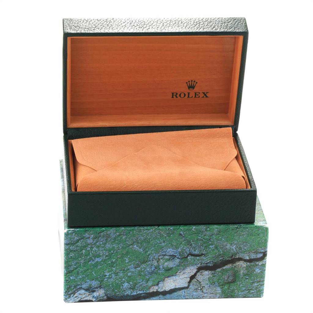 This image shows an open Rolex Date 15200 Men's Stainless Steel Black Dial 15200 Men's Stainless Steel Black Dial model watch box with an orange interior lining and green exterior.