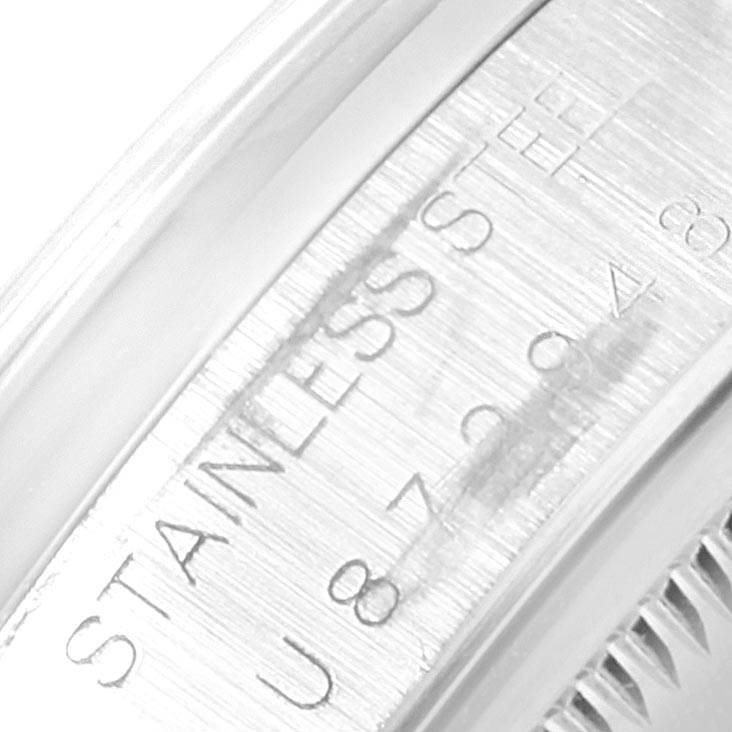 This close-up image shows the serial engraving on the stainless steel case of a Rolex Date 15200 Men's Stainless Steel Black Dial 15200 Men's Stainless Steel Black Dial model watch.