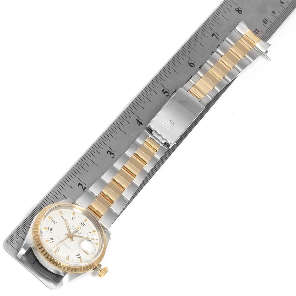 The image shows a top-down view of a Rolex Date 15053 Men's Steel and Gold (two tone) White Dial 15053 Men's Steel and Gold (two tone) White Dial model watch with its strap laid flat next to a ruler.