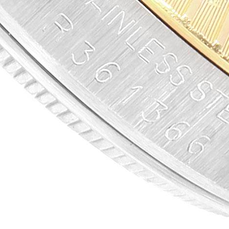 The image shows a close-up of the edge of a stainless steel Rolex Date 15053 Men's Steel and Gold (two tone) White Dial 15053 Men's Steel and Gold (two tone) White Dial model watch, highlighting its fluted bezel and engraved text.