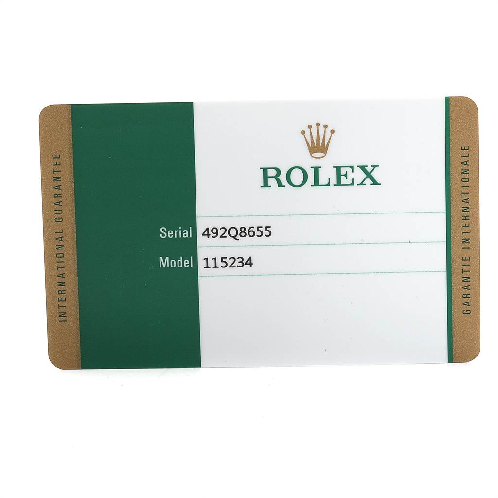 This image shows the international guarantee card for a Rolex Date 115234 Men's Stainless Steel White Dial 115234 Men's Stainless Steel White Dial model watch, displaying the serial and model numbers.