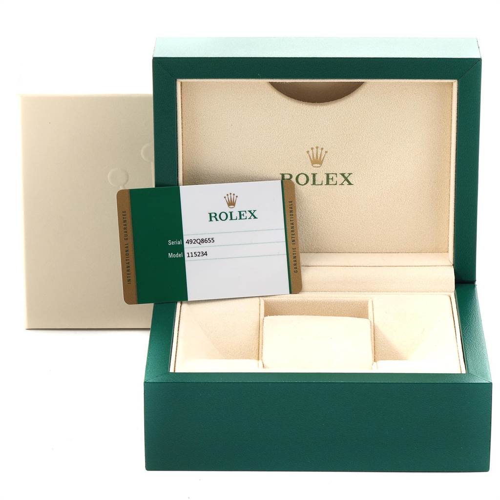 The image shows the box and guarantee card of a Rolex Date 115234 Men's Stainless Steel White Dial 115234 Men's Stainless Steel White Dial model watch.