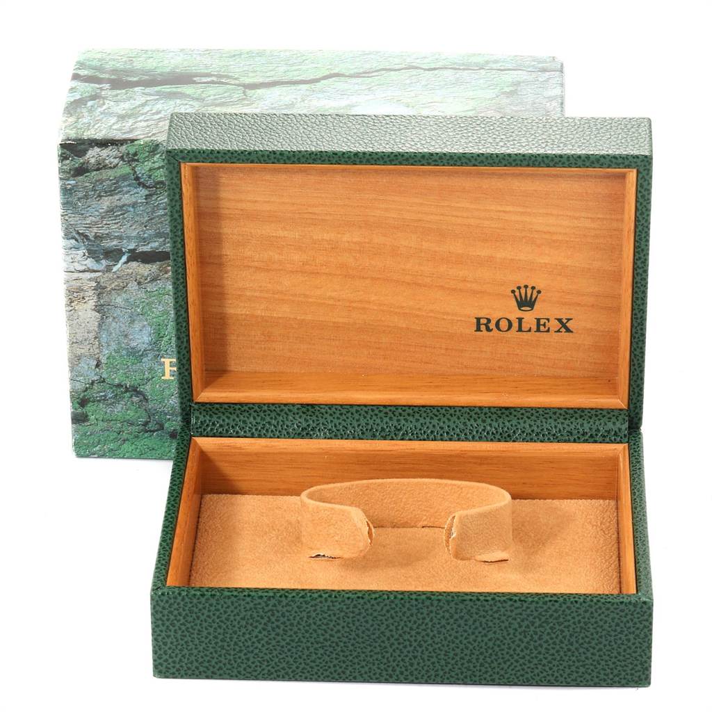 The image shows an open Rolex box for a Date model watch, displaying the inner wooden compartment and watch cushion.