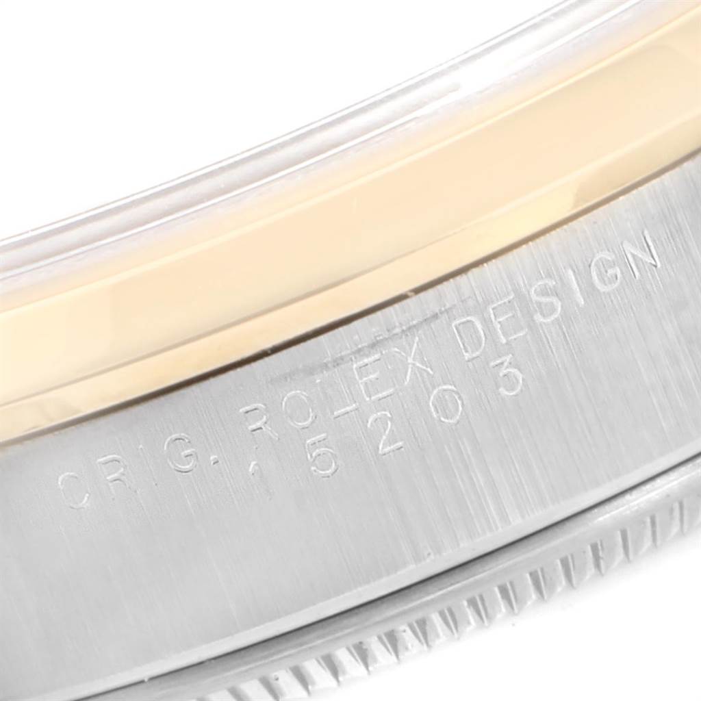 This image shows a close-up of the engraved case back and bezel area of a Rolex Date 15203 Men's Steel and Gold (two tone) Silver Dial 15203 Men's Steel and Gold (two tone) Silver Dial model.