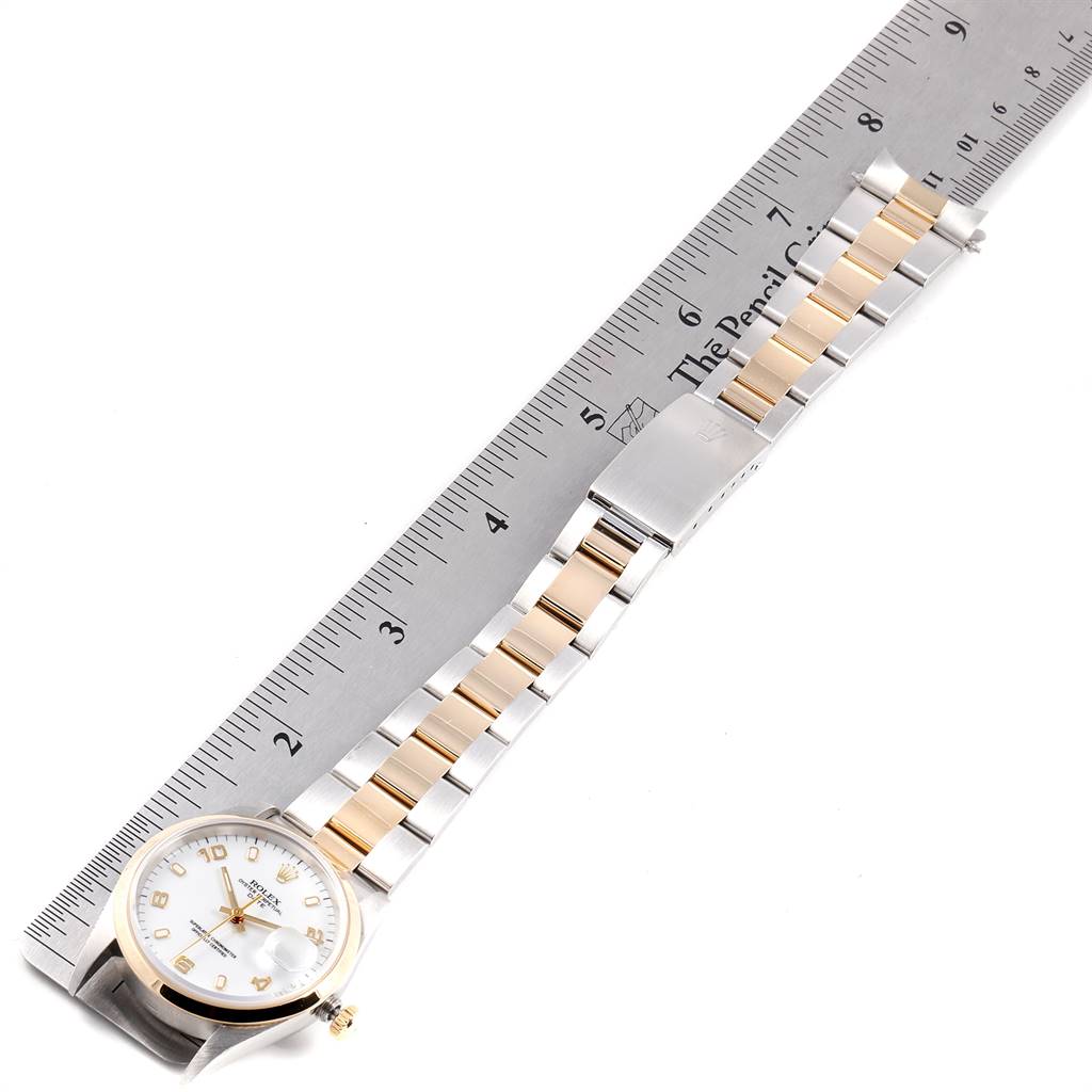 This image shows a top view of a Rolex Date 15203 Men's Steel and Gold (two tone) White Dial 15203 Men's Steel and Gold (two tone) White Dial model watch, including its dial, bezel, and a two-tone bracelet against a ruler for scale.