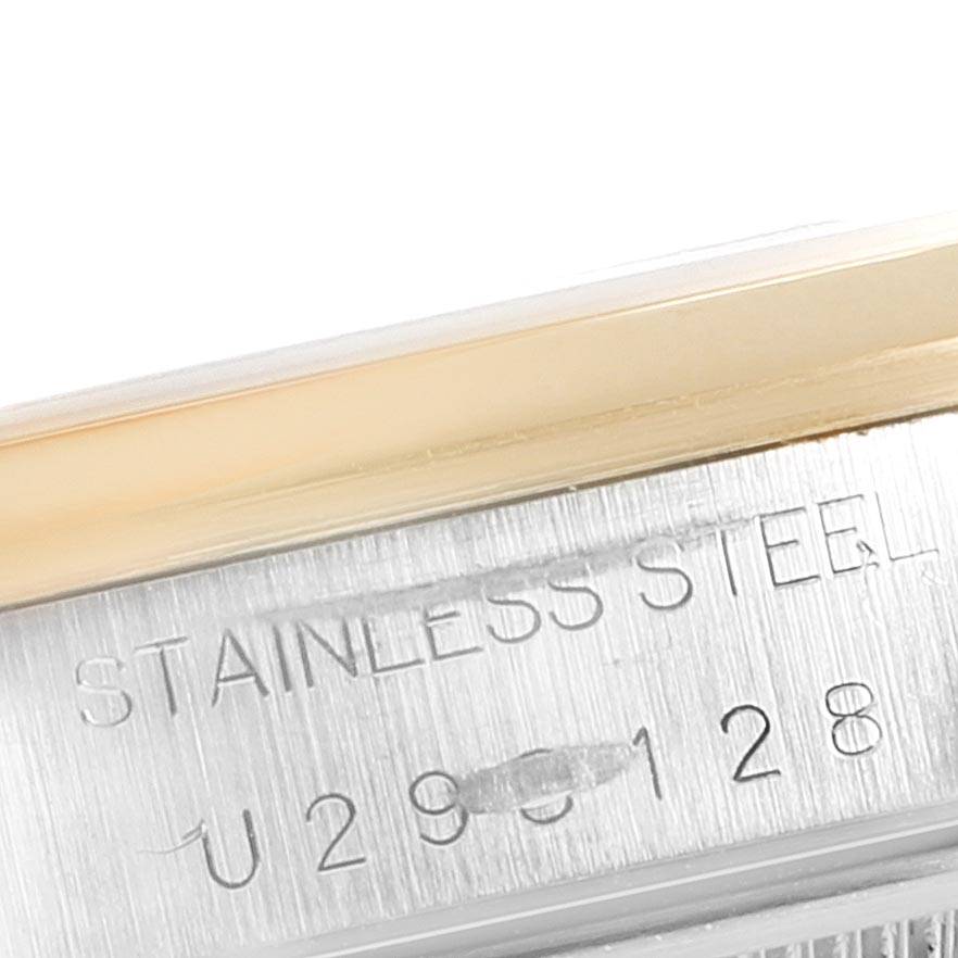 The image shows a close-up of the case side and bezel of a Rolex Date 15203 Men's Steel and Gold (two tone) White Dial 15203 Men's Steel and Gold (two tone) White Dial model, highlighting the stainless steel material and serial number.