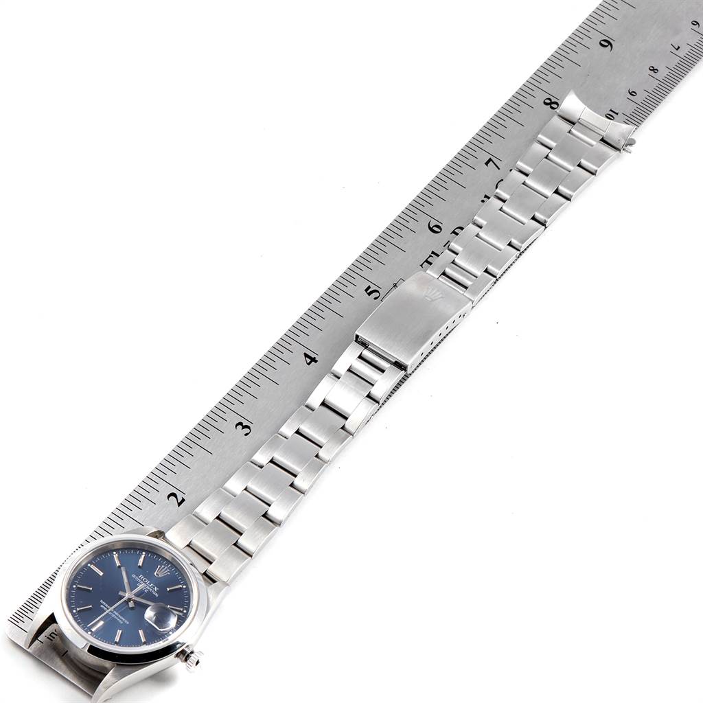 The image shows a top-down view of a Rolex Date 15200 Men's Stainless Steel Blue Dial 15200 Men's Stainless Steel Blue Dial model watch, highlighting the face, band, and clasp next to a ruler.