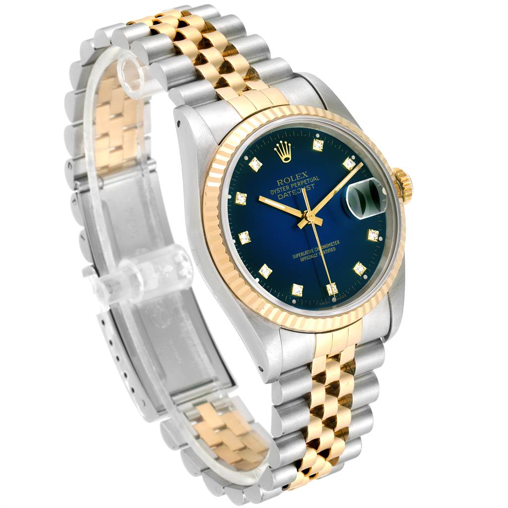 This Rolex Date 16233 Men's Steel and Gold (two tone) Blue Dial 16233 Men's Steel and Gold (two tone) Blue Dial model is shown at a slight angle, highlighting the two-tone bracelet, blue dial, and fluted bezel.