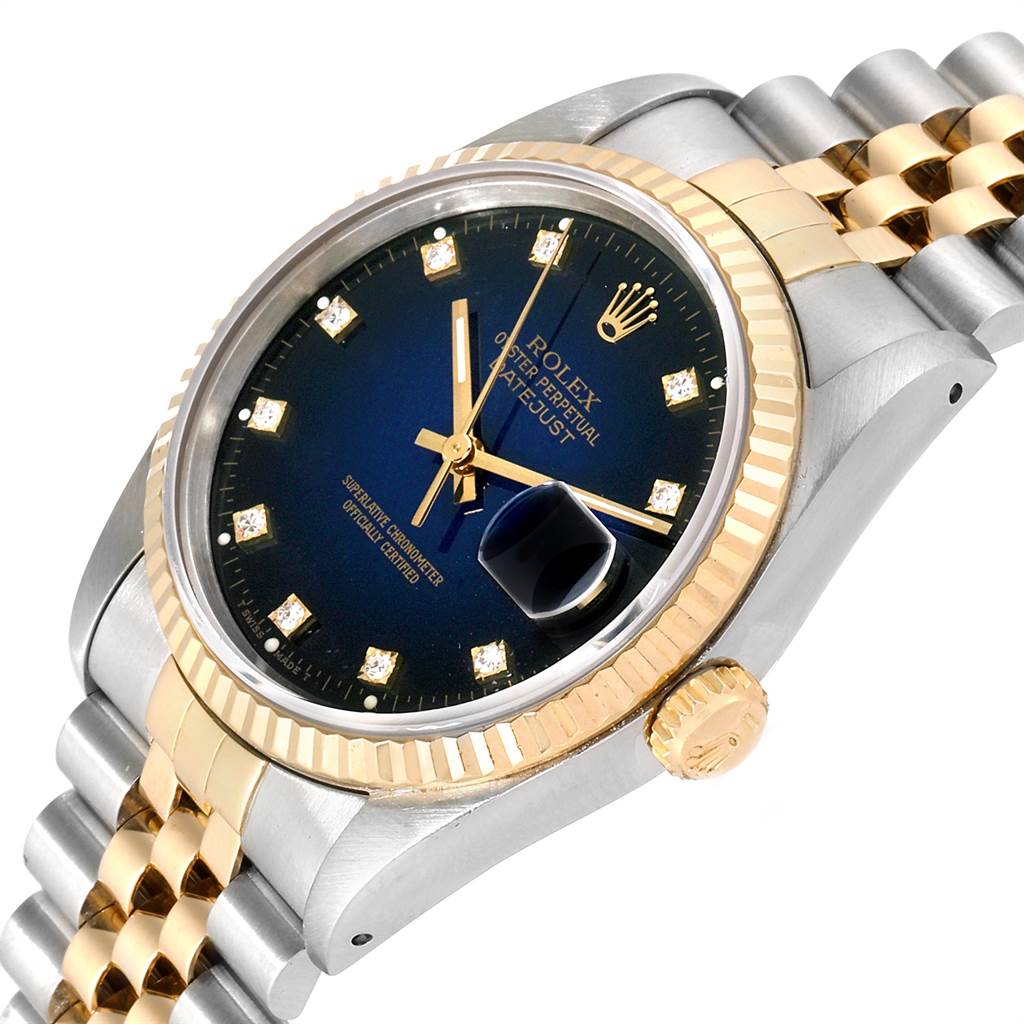 The image shows a Rolex Date 16233 Men's Steel and Gold (two tone) Blue Dial 16233 Men's Steel and Gold (two tone) Blue Dial model watch with a fluted bezel, jubilee bracelet, and a blue dial with diamond hour markers.
