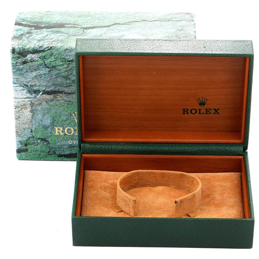 The image shows an open green and wood Rolex watch box for a Date model, with a plush cushion inside.