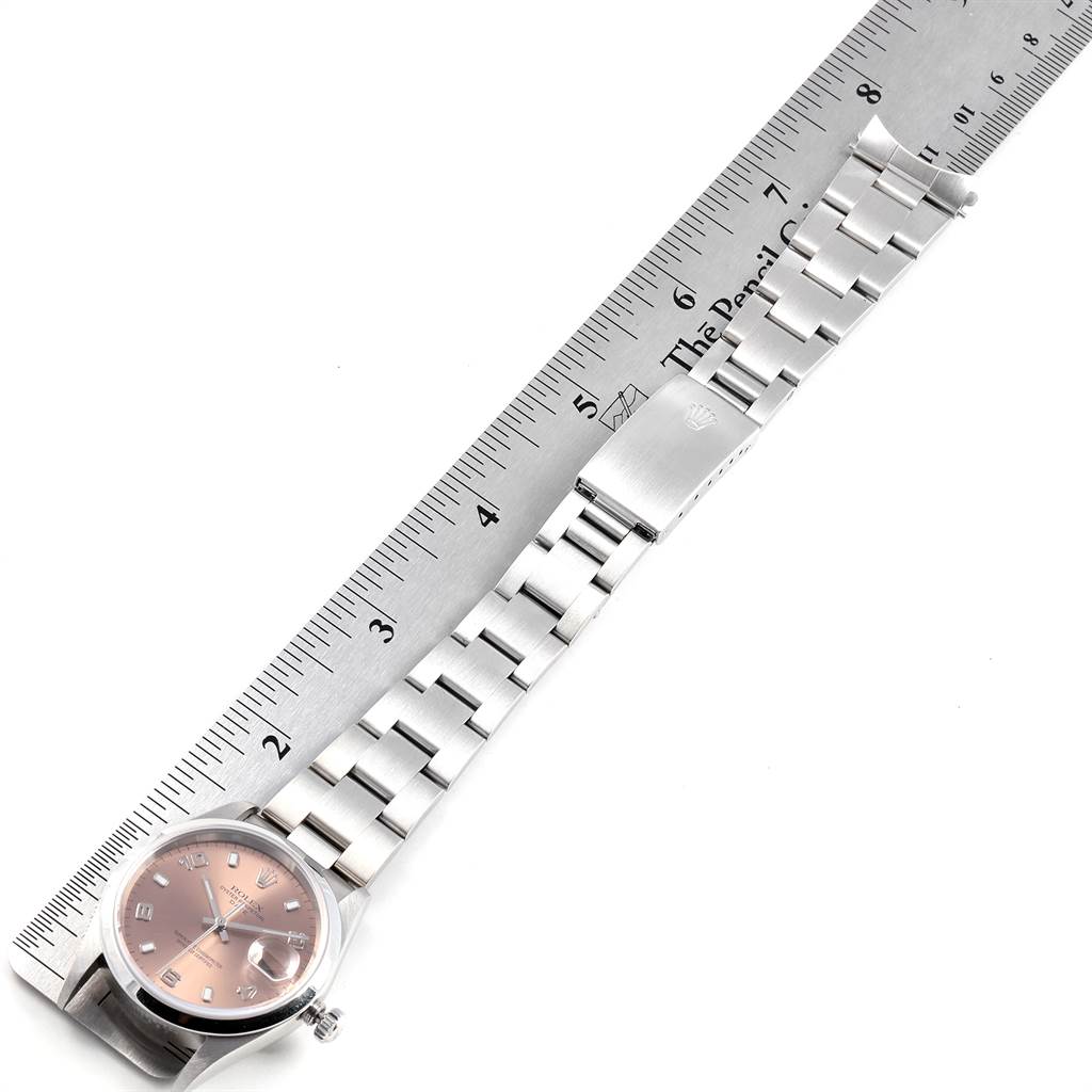 The image shows a Rolex Date 15200 Men's Stainless Steel Pink Dial 15200 Men's Stainless Steel Pink Dial watch with a stainless steel band and clasp, measured alongside a ruler.