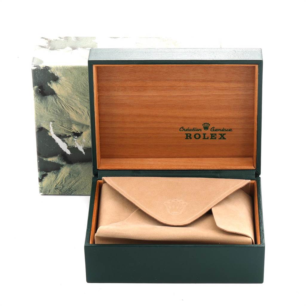This image shows a Rolex Date 15053 Men's Steel and Gold (two tone) Silver Dial 15053 Men's Steel and Gold (two tone) Silver Dial model's open green and wooden box with an enclosed tan pouch inside.