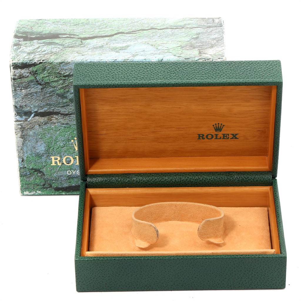 The image shows an open green and wooden Rolex watch box designed for the Date model, with its cushion inside.