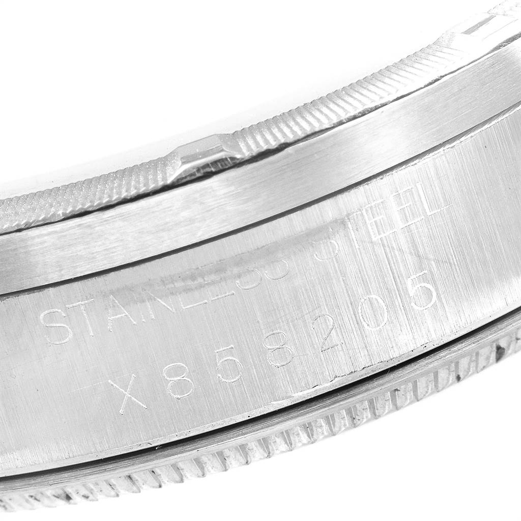 The image shows a close-up of the stainless steel case back and serial number of a Rolex Date 15210 Men's Stainless Steel Blue Dial 15210 Men's Stainless Steel Blue Dial model watch.