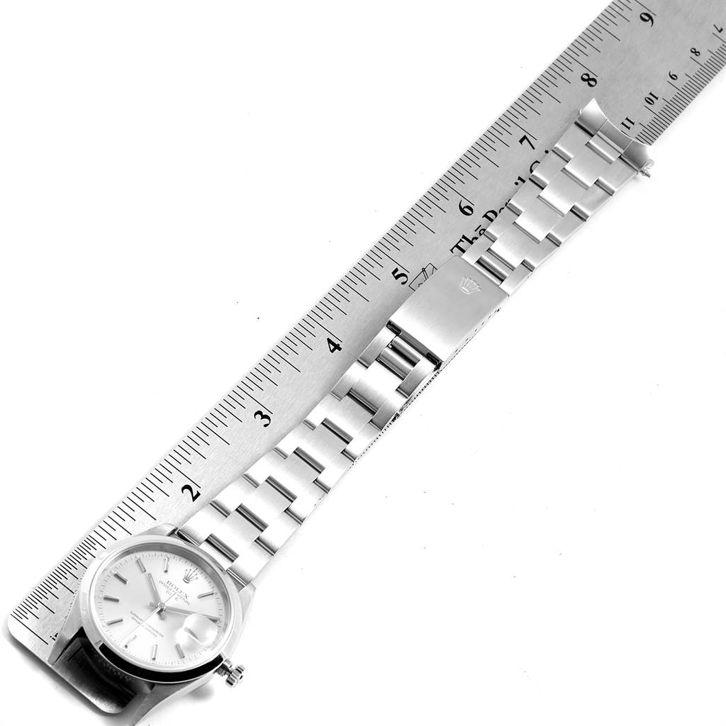 The image shows a top view of a Rolex Date 15200 Men's Stainless Steel Silver Dial 15200 Men's Stainless Steel Silver Dial model watch with a metal bracelet and a ruler measuring its length.