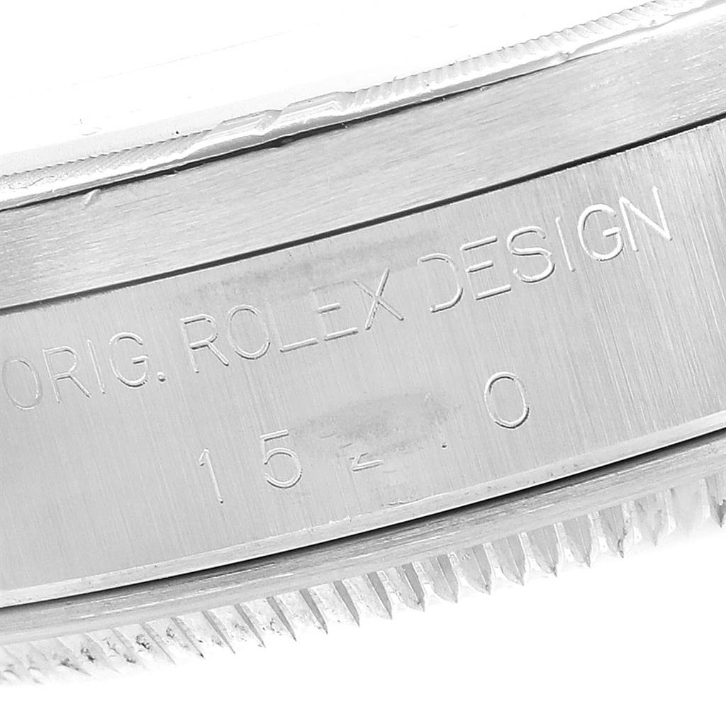 The image shows a close-up of the case side of a Rolex Date 15210 Men's Stainless Steel White Dial 15210 Men's Stainless Steel White Dial model, displaying engraved text and part of the bezel.