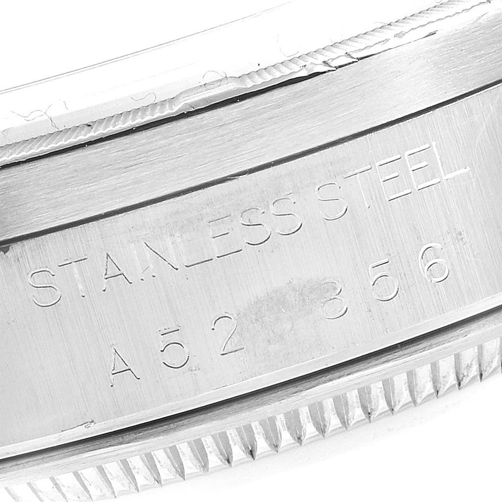 The image shows a close-up of the engraved side case of a Rolex Date 15210 Men's Stainless Steel White Dial 15210 Men's Stainless Steel White Dial model watch, featuring the text "STAINLESS STEEL."