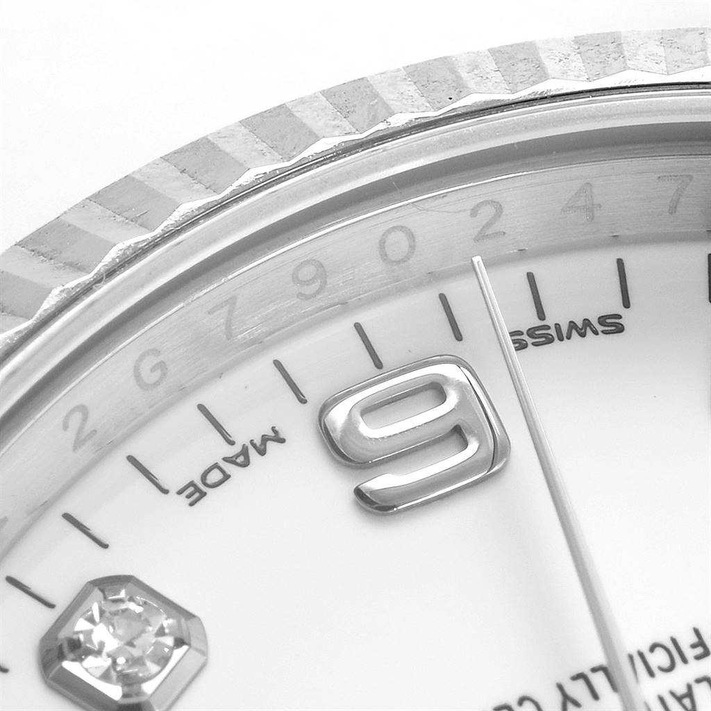 The image shows a close-up of the dial and partial bezel of a Rolex Date 115234 Men's Stainless Steel White Dial 115234 Men's Stainless Steel White Dial watch, highlighting the numeral '9' and detailed markings.