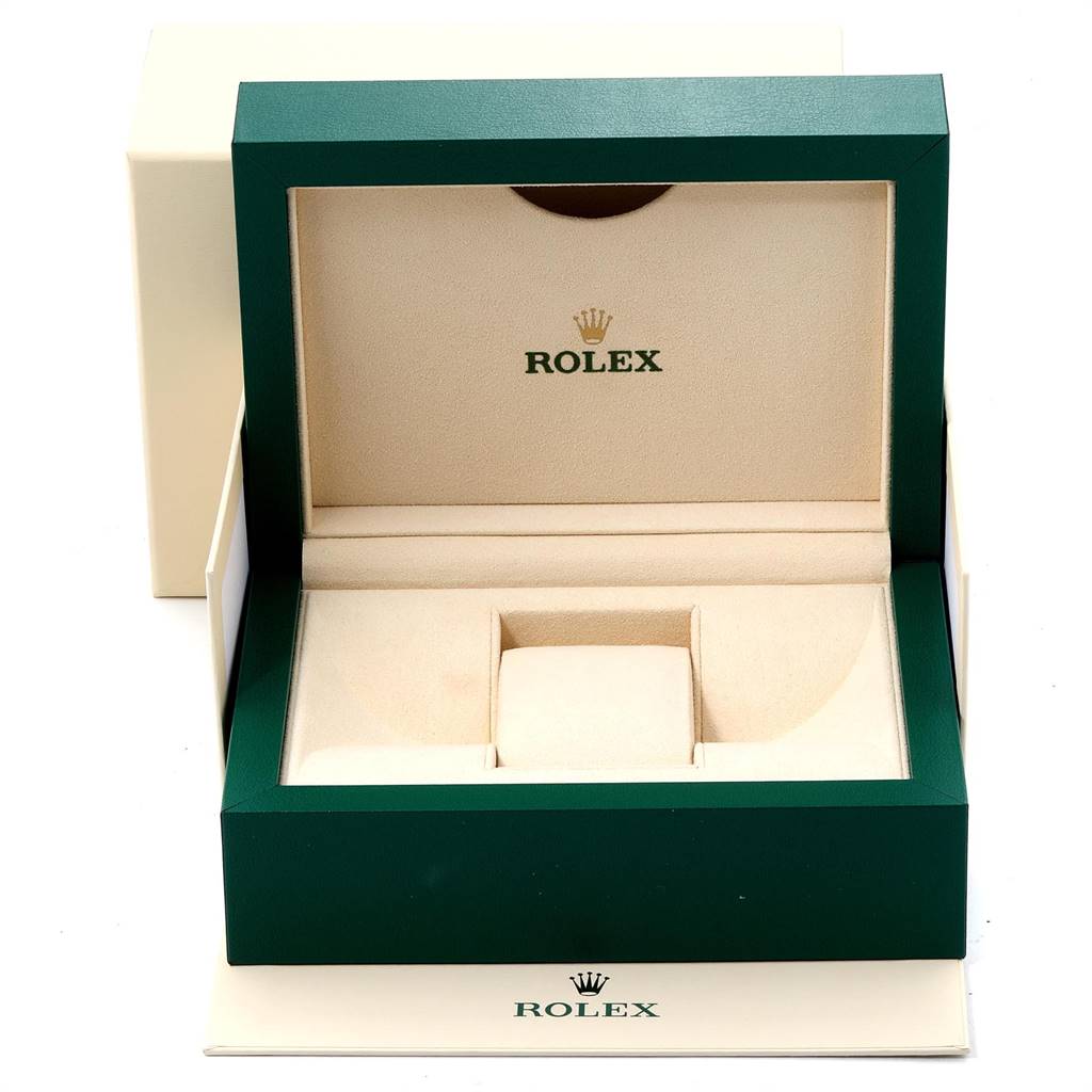 This is an open, empty Rolex Date 115234 Men's Stainless Steel White Dial 115234 Men's Stainless Steel White Dial watch box and accessories from a front angle.