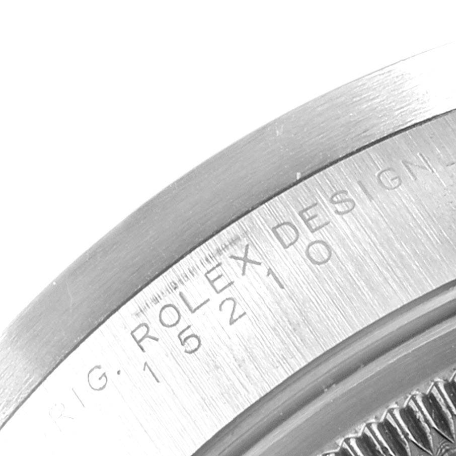 This close-up angle of a Rolex Date 15210 Men's Stainless Steel Blue Dial 15210 Men's Stainless Steel Blue Dial model shows part of the bezel and the engraving on the case.