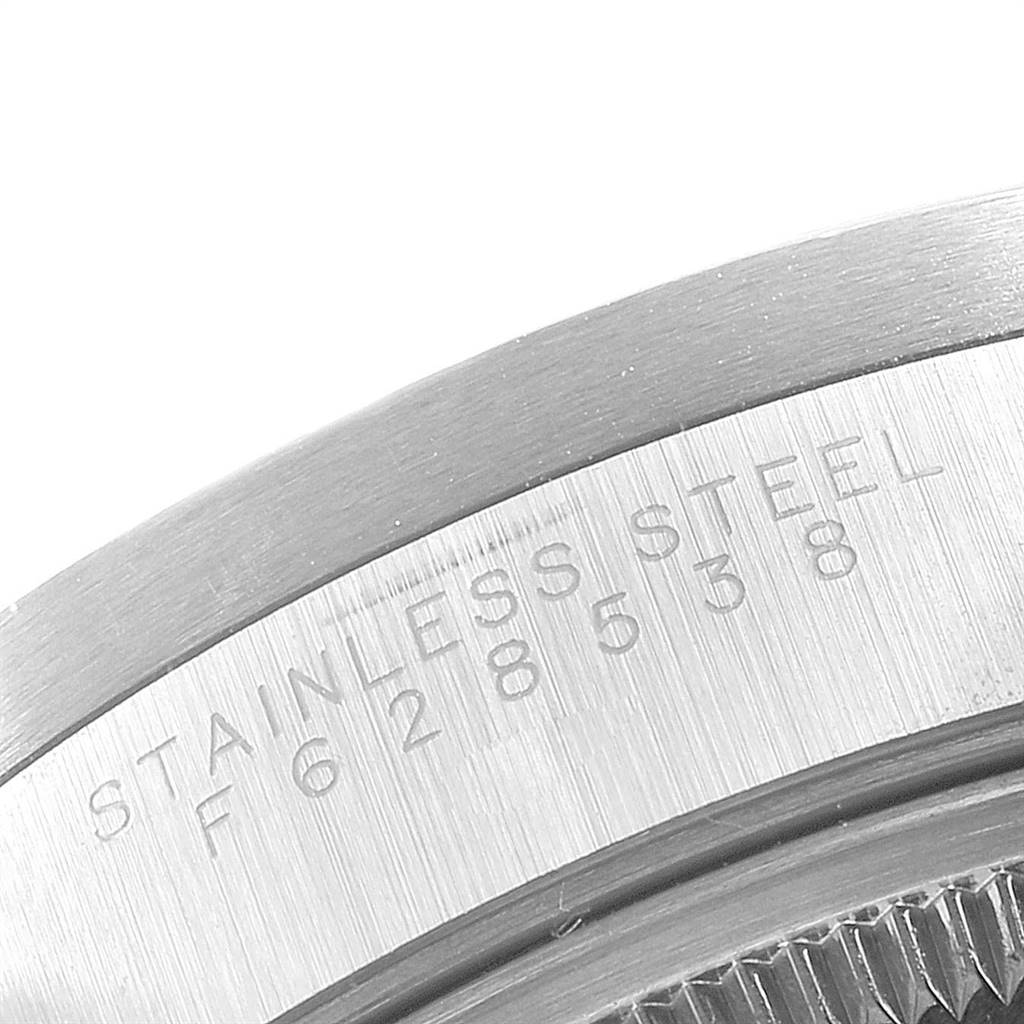 The image shows a close-up of the engravings on the stainless steel case back of a Rolex Date 15210 Men's Stainless Steel Blue Dial 15210 Men's Stainless Steel Blue Dial model watch.