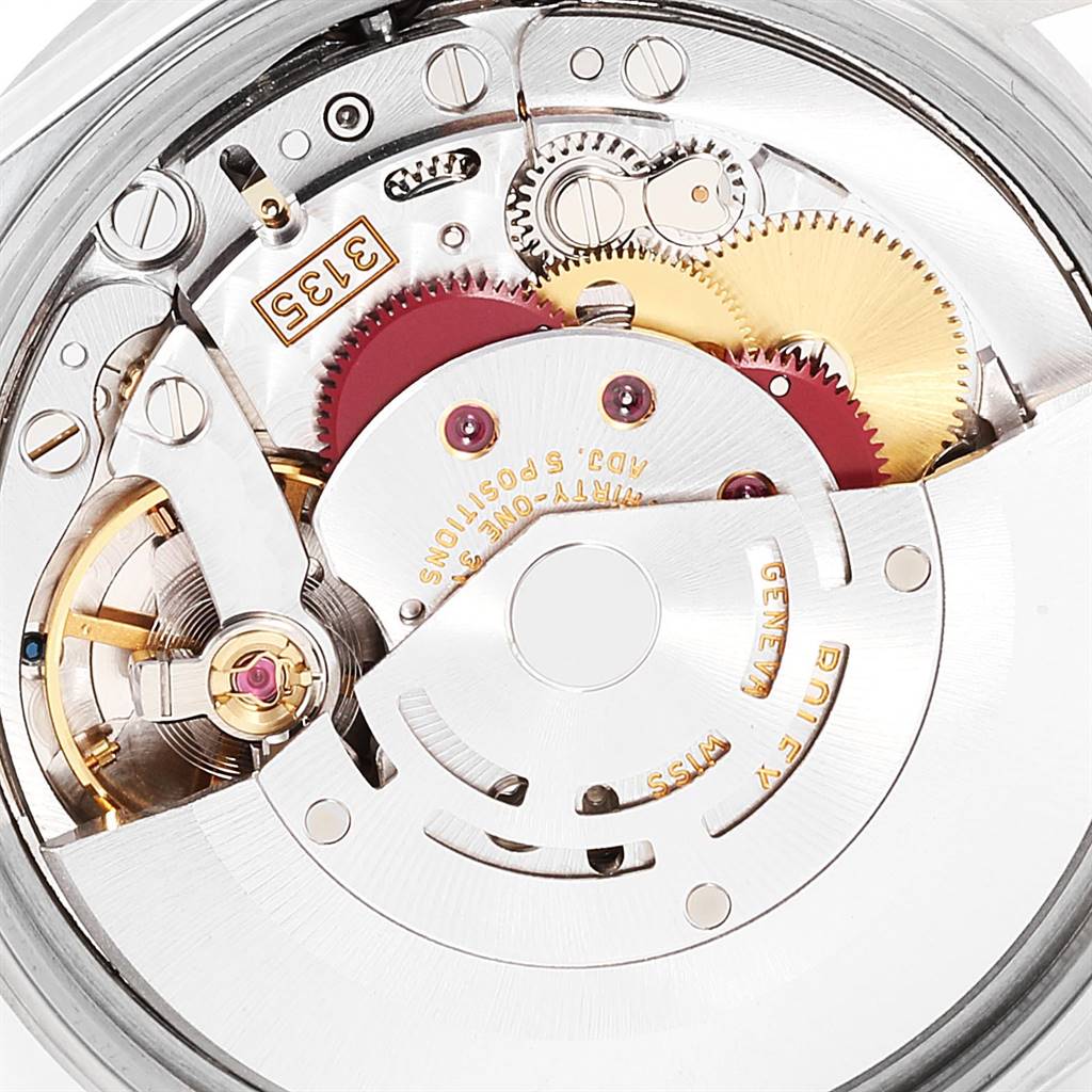 The image shows a close-up view of the internal mechanism of a Rolex Date 15210 Men's Stainless Steel Blue Dial 15210 Men's Stainless Steel Blue Dial model watch, displaying the gears and movement components.