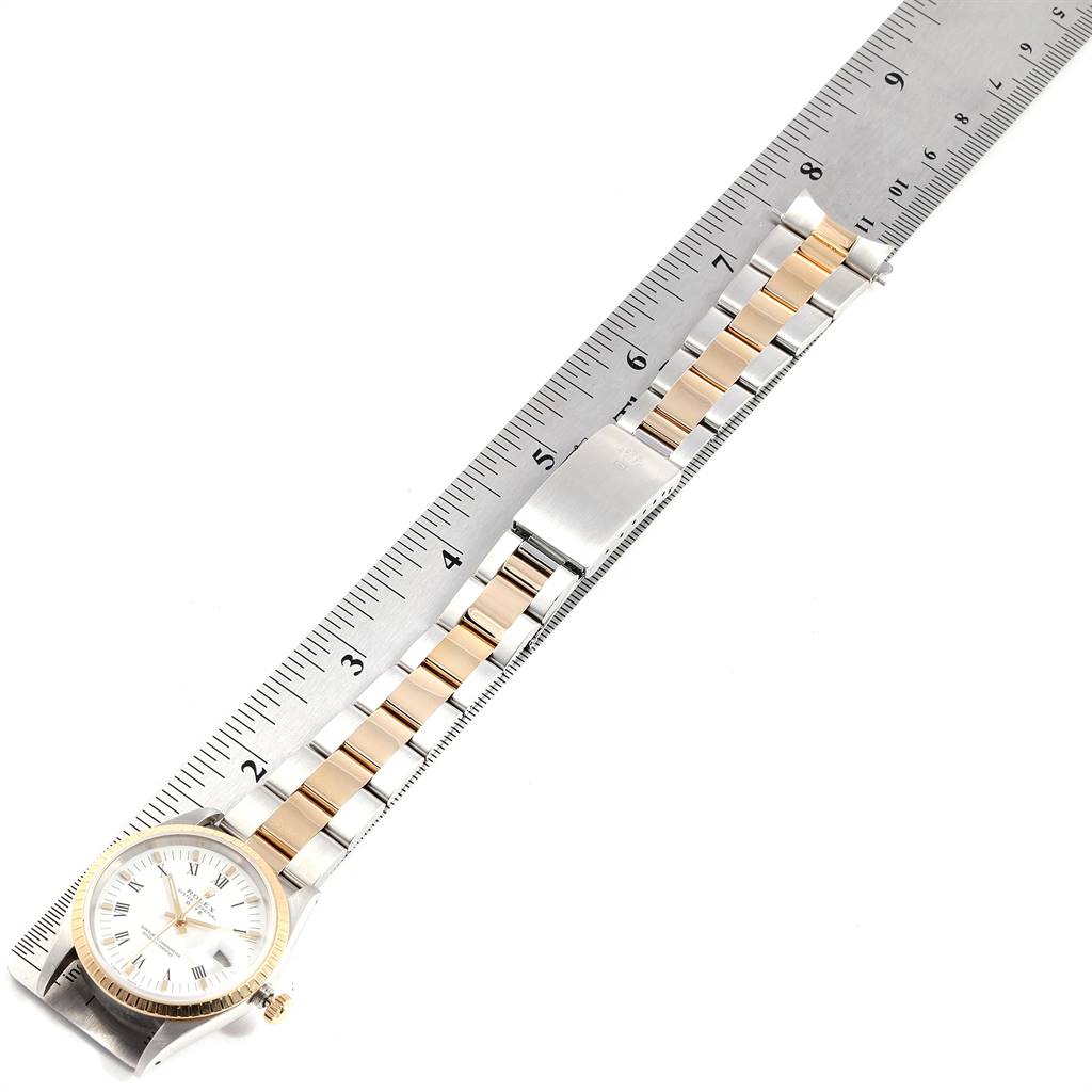 The image shows a top-down view of the Rolex 15223 Men's Steel and Gold (two tone) White Dial 15223 Men's Steel and Gold (two tone) White Dial Date Mens Steel 18k Yellow Gold White Dial Mens Watch 15223 alongside a ruler.