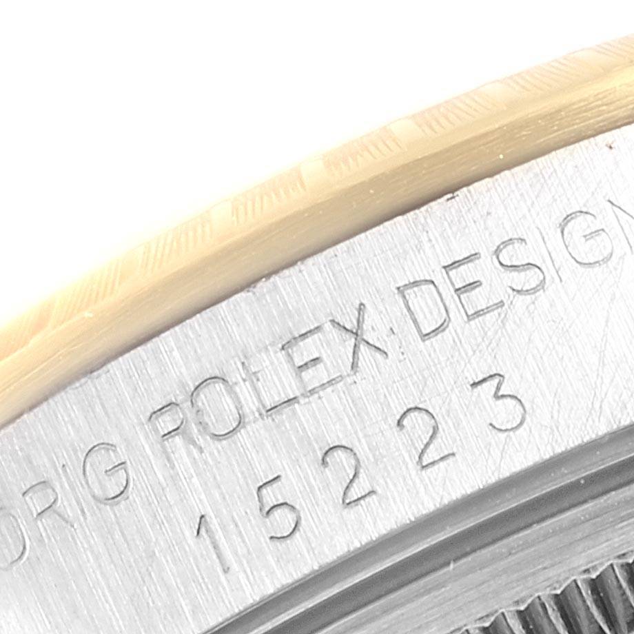 This close-up image shows the model number 15223 and "Rolex 15223 Men's Steel and Gold (two tone) White Dial 15223 Men's Steel and Gold (two tone) White Dial Design" engraving on the case of a Rolex 15223 Men's Steel and Gold (two tone) White Dial 15223 Men's Steel and Gold (two tone) White Dial Date Men's Steel 18k Yellow Gold White Dial Watch.