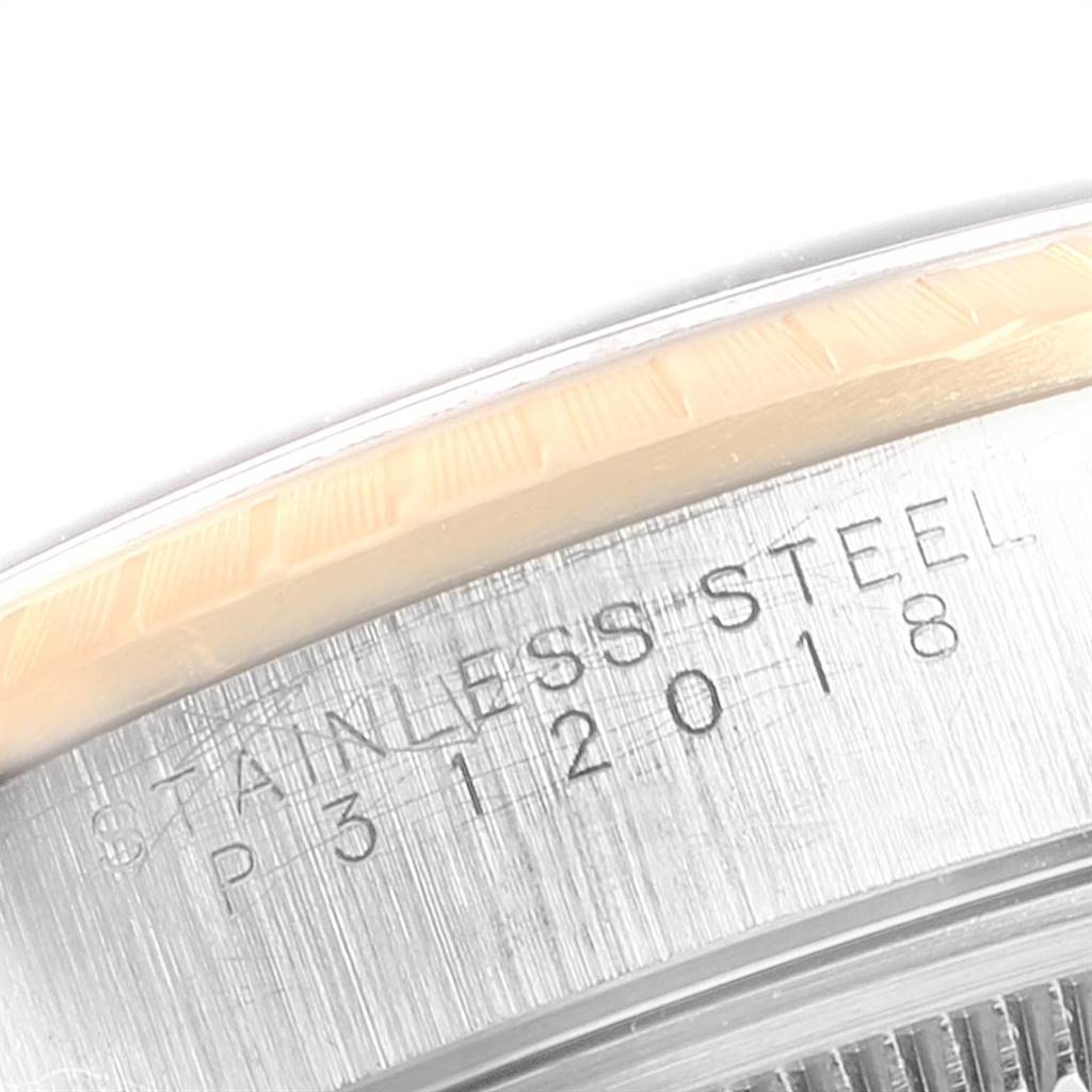 Close-up of the side of the case of a Rolex Date 15223 Men's Steel and Gold (two tone) Blue Dial 15223 Men's Steel and Gold (two tone) Blue Dial model watch, showing the stainless steel engraving and part of the bezel.