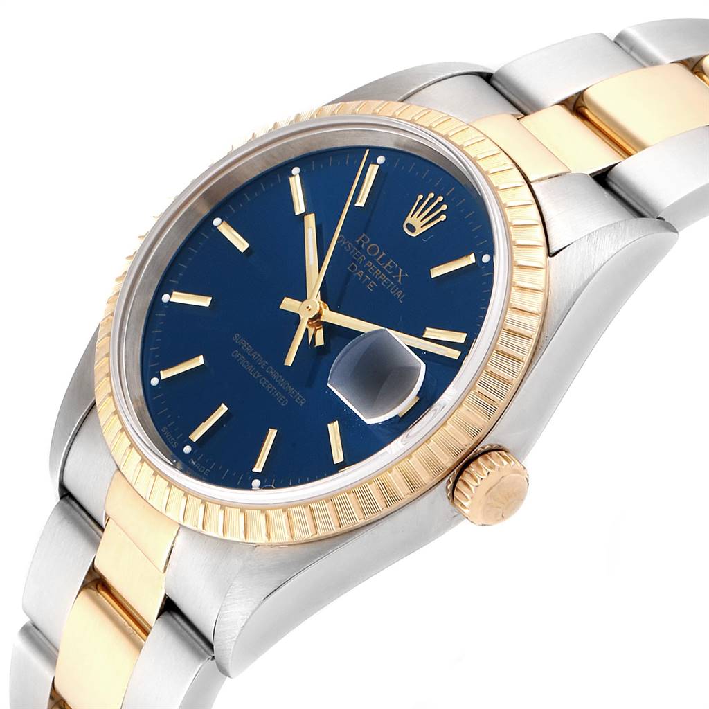 The Rolex Date 15223 Men's Steel and Gold (two tone) Blue Dial 15223 Men's Steel and Gold (two tone) Blue Dial model watch is shown at an angle displaying its blue dial, gold fluted bezel, and two-tone bracelet.