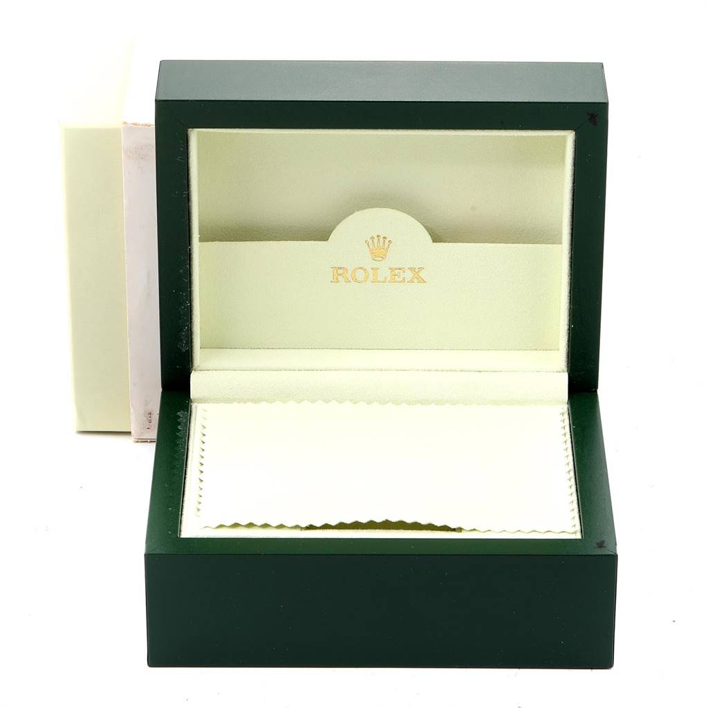 This image shows an open Rolex Date 15223 Men's Steel and Gold (two tone) Blue Dial 15223 Men's Steel and Gold (two tone) Blue Dial model watch box with a green exterior and cream interior.