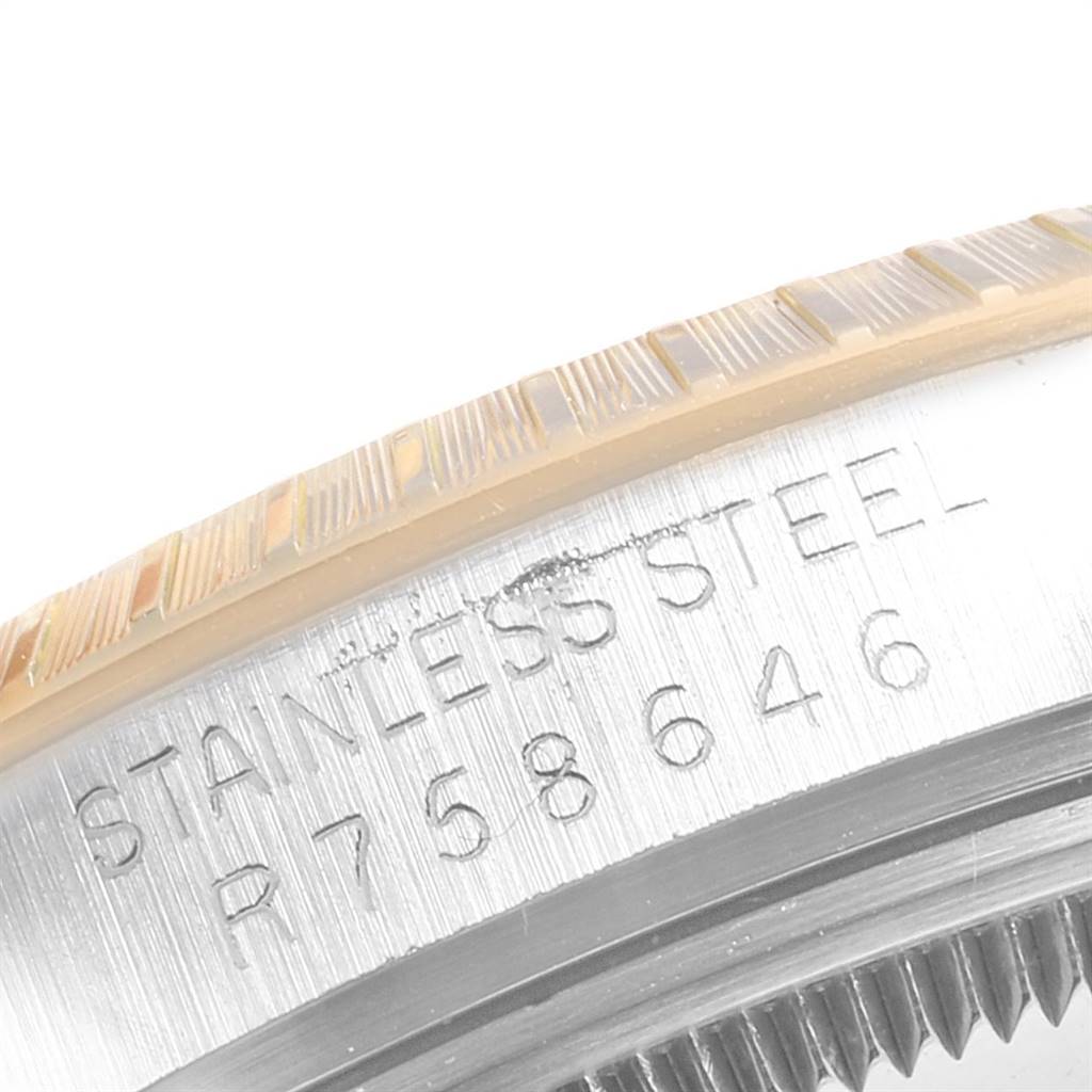 This close-up image shows the stainless steel casing and serial engraving of a Rolex Date 15053 Men's Steel and Gold (two tone) Champagne Dial 15053 Men's Steel and Gold (two tone) Champagne Dial model watch.