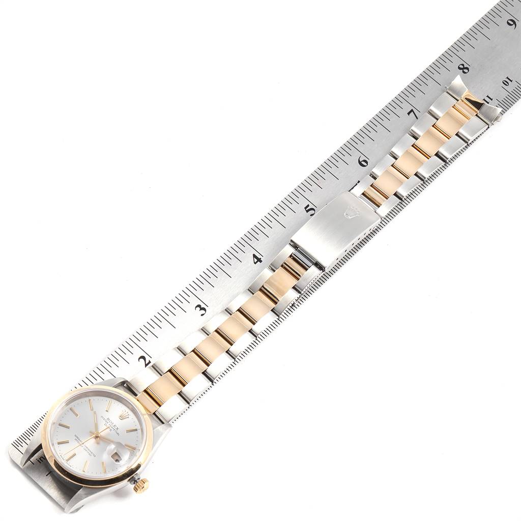The image shows a top-down view of a Rolex Date 15203 Men's Steel and Gold (two tone) Silver Dial 15203 Men's Steel and Gold (two tone) Silver Dial model watch, measuring its bracelet against a ruler.