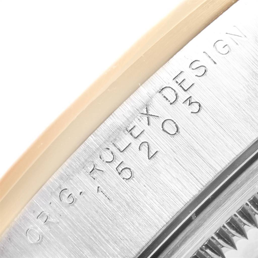 This close-up angle of a Rolex Date 15203 Men's Steel and Gold (two tone) Silver Dial 15203 Men's Steel and Gold (two tone) Silver Dial model watch shows the engraved "ORIG. ROLEX DESIGN" and part of the case.