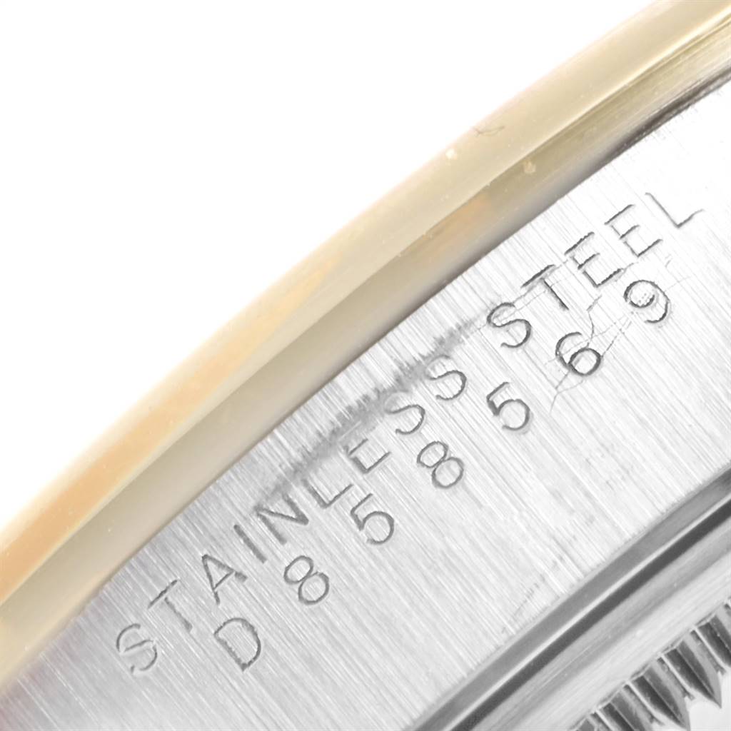 This image shows a close-up of the engraved case back of a Rolex Date 15203 Men's Steel and Gold (two tone) Silver Dial 15203 Men's Steel and Gold (two tone) Silver Dial model, indicating it is made of stainless steel.