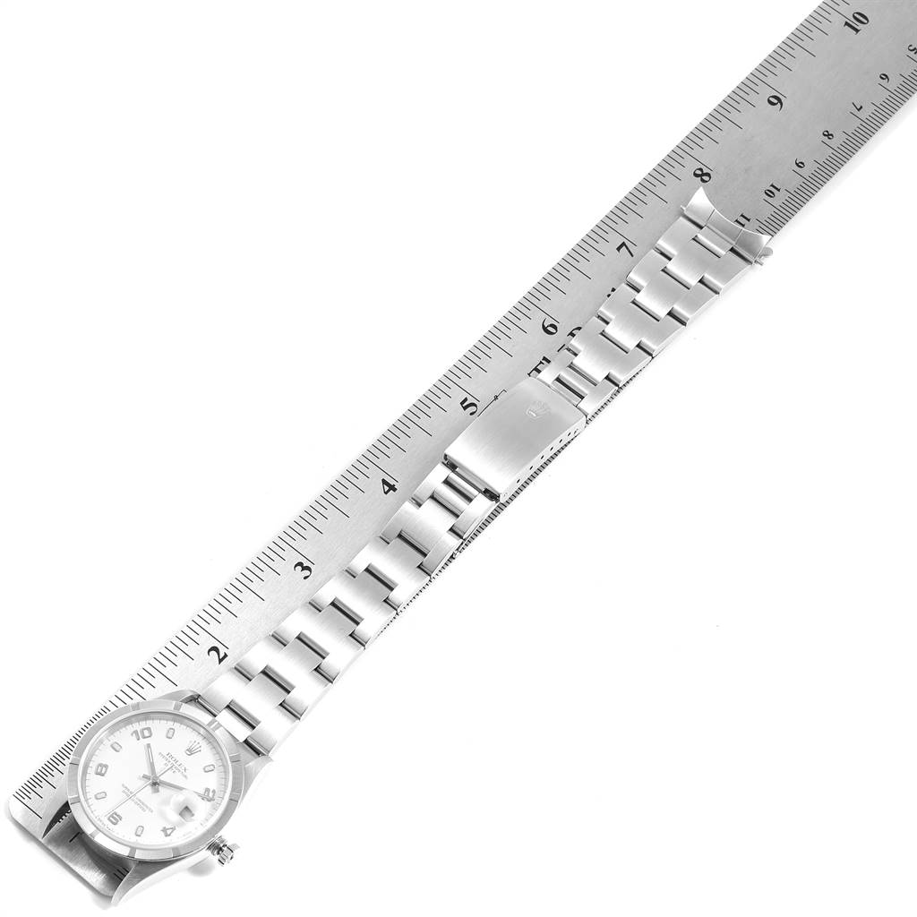The image shows a Rolex Date 15210 Men's Stainless Steel White Dial 15210 Men's Stainless Steel White Dial model watch laid flat, with a ruler alongside to measure its length.