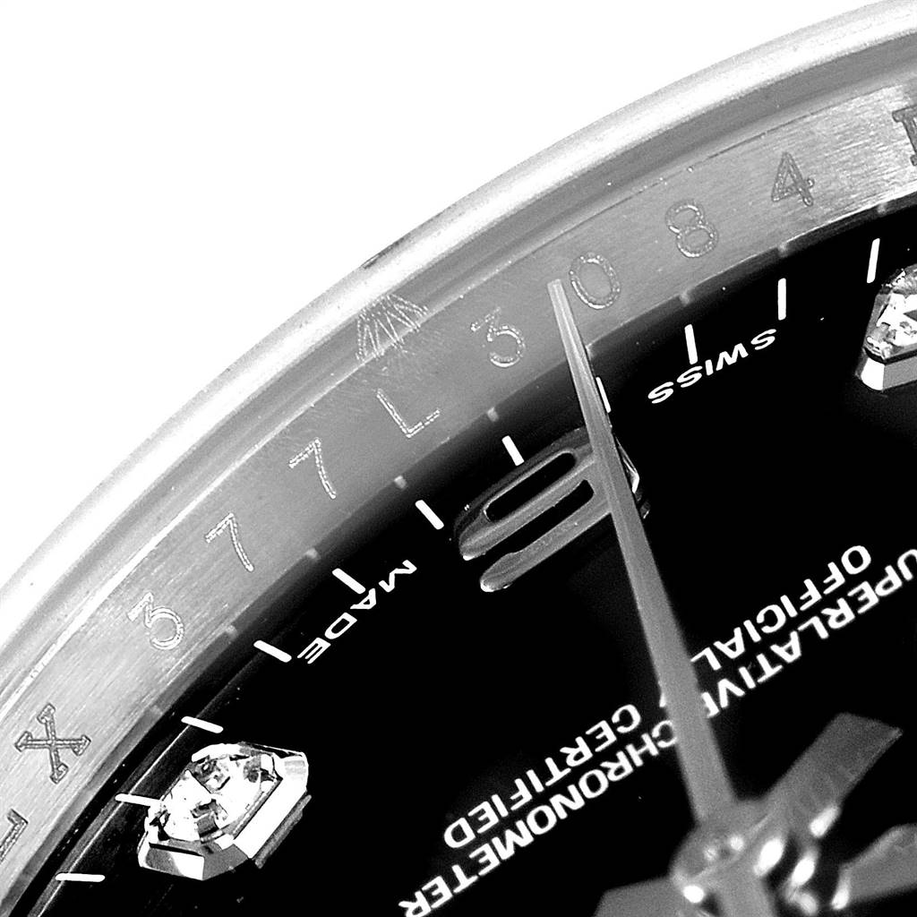 This is a close-up image showing a portion of the dial and chapter ring of a Rolex Date 115234 Men's Stainless Steel Black Dial 115234 Men's Stainless Steel Black Dial model watch.