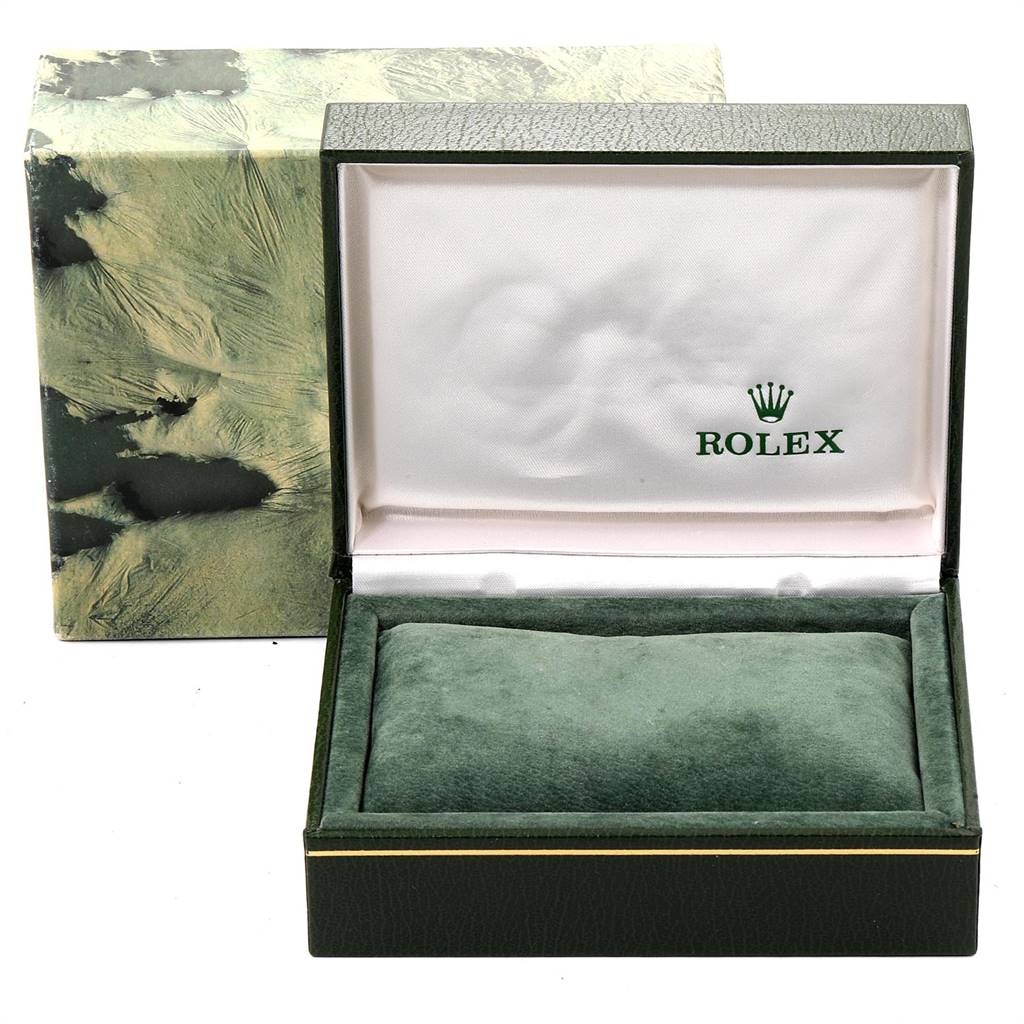 The image shows an open green Rolex box for the Date model, revealing the inner cushioned pillow but not the watch itself.