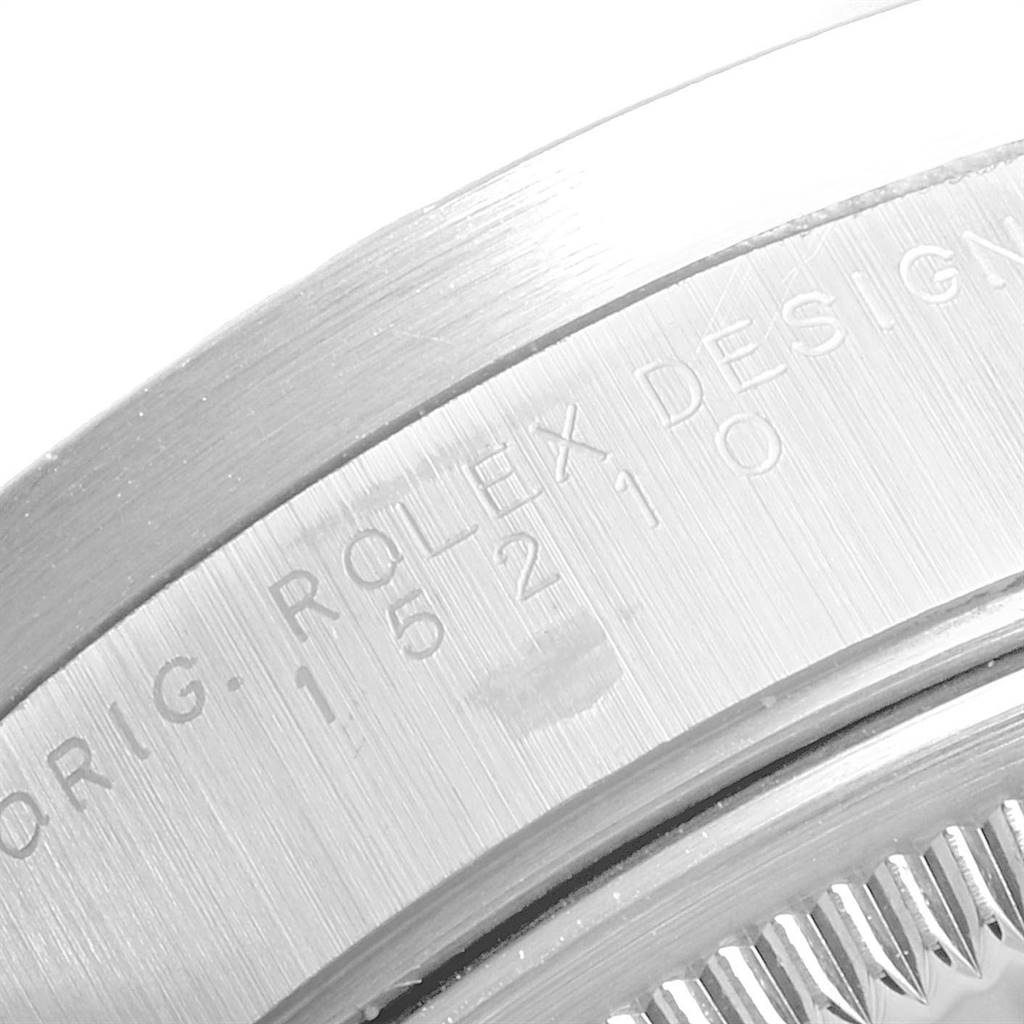 The image shows a close-up of the engraved case back of a Rolex Date 15210 Men's Stainless Steel Silver Dial 15210 Men's Stainless Steel Silver Dial watch, focusing on its serial number and branding.