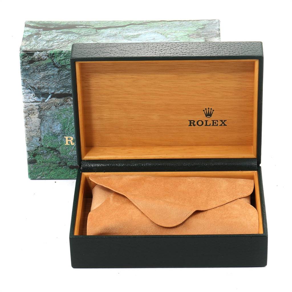 The image shows an open Rolex watch box with a suede pouch inside, placed at a front angle.