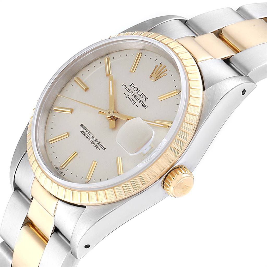 The Rolex Date 15223 Men's Steel and Gold (two tone) Silver Dial 15223 Men's Steel and Gold (two tone) Silver Dial watch is shown at an oblique angle, displaying the dial, bezel, crown, and part of the bracelet.